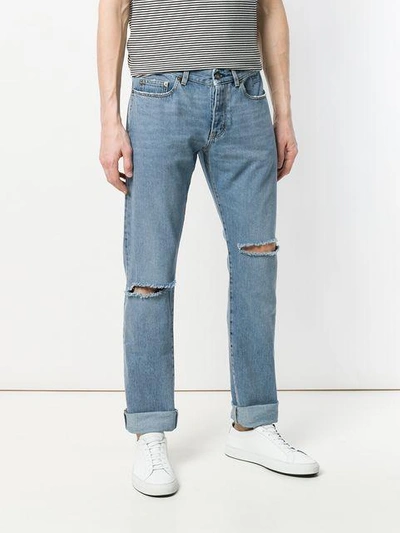 Shop Saint Laurent Distressed Low-rise Jeans In Blue