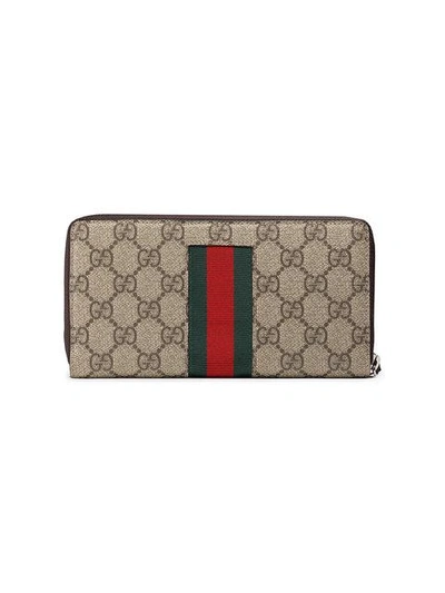 Shop Gucci Web Gg Supreme Zip Around Wallet In Brown