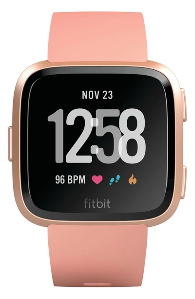 Shop Fitbit Versa Smart Watch In Peach / Rose Gold
