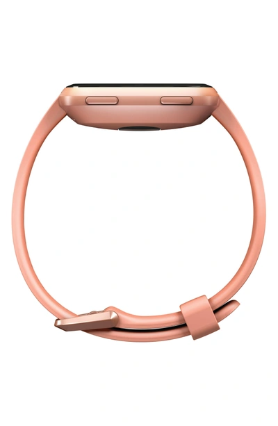 Shop Fitbit Versa Smart Watch In Peach / Rose Gold