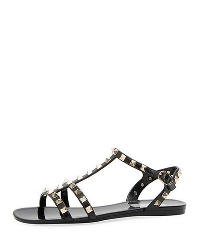 Shop Valentino Rockstud Jelly Flat Gladiator Sandals In Nero