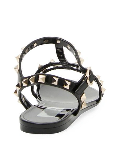 Shop Valentino Rockstud Jelly Flat Gladiator Sandals In Nero