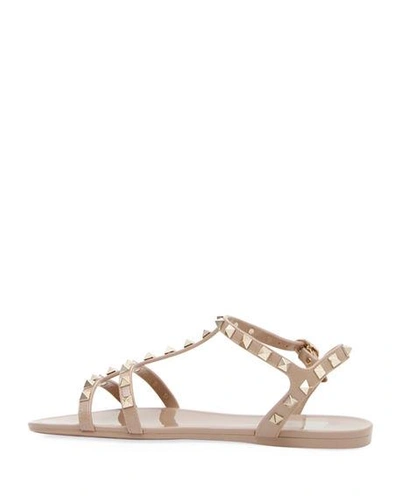 Shop Valentino Rockstud Jelly Flat Gladiator Sandals In Poudre