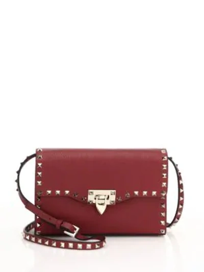 Shop Valentino Rockstud Medium Leather Crossbody Bag In Dark Red