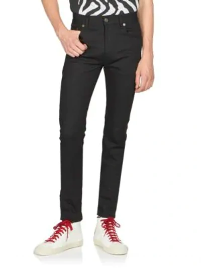 Shop Saint Laurent Skinny Stretch-cotton Jeans In Black