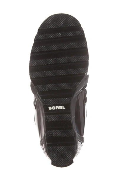 Shop Sorel Joan Glossy Wedge Rain Boot In Black/ Sea Salt