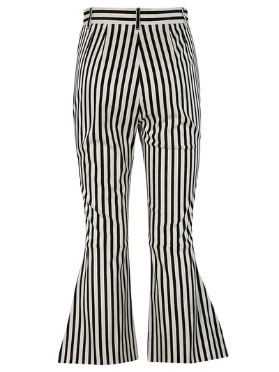 Shop Dolce & Gabbana Flared Striped Cropped Trousers In White Black