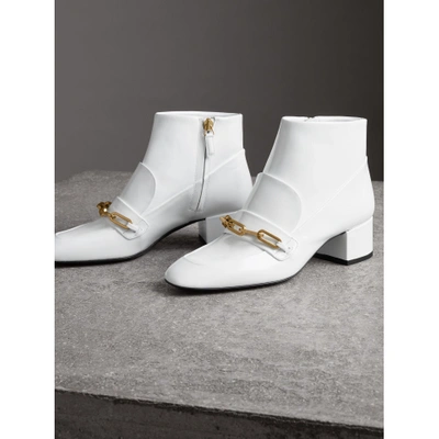 Shop Burberry Link Detail Patent Leather Ankle Boots In Optic White