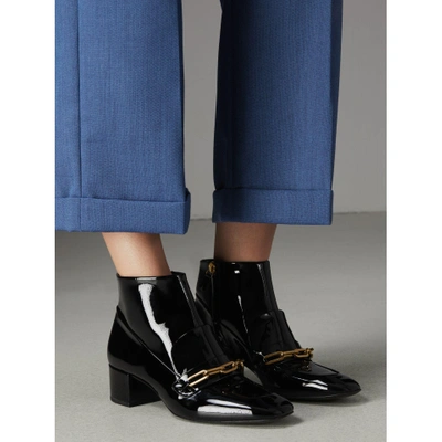 Shop Burberry Link Detail Patent Leather Ankle Boots In Black