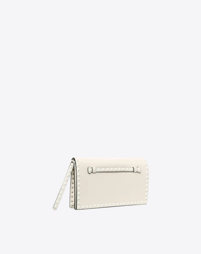 Shop Valentino Lacquer Rockstud Wristlet Clutch In Light Ivory