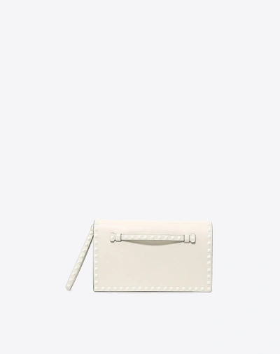 Shop Valentino Lacquer Rockstud Wristlet Clutch In Light Ivory