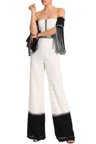 Shop Alexis Off-the-shoulder Fringe-trimmed Corded Lace Jumpsuit In Off-white