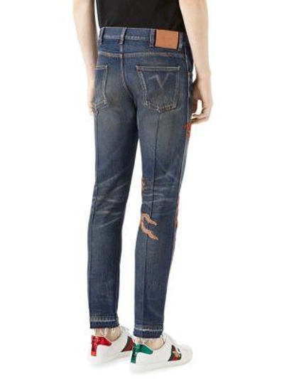 Shop Gucci Embroidered Dragon Stone-washed Tapered Jeans In Blue