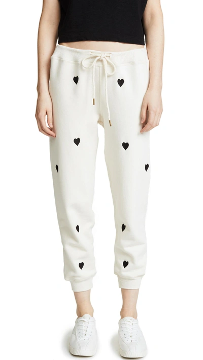 Shop The Great The Cropped Sweatpants In Washed White With Black Hearts