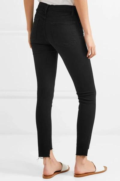 Shop Frame Le Skinny De Jeanne Raw Stagger Mid-rise Jeans In Black