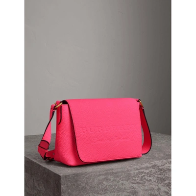 Shop Burberry Small Embossed Neon Leather Messenger Bag In Neon Pink