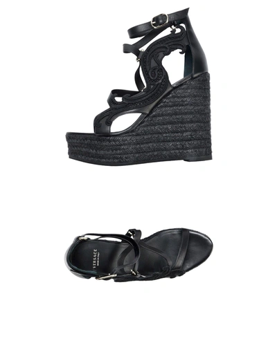 Shop Versace Sandals In Black