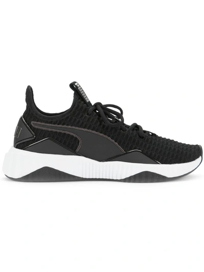 Shop Puma Defy Sneakers - Black
