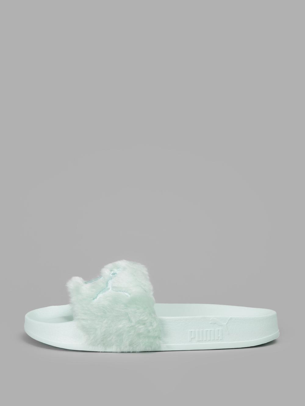 light blue puma slides