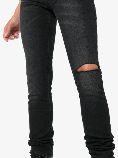 Shop Saint Laurent Ripped Skinny Jeans In Black