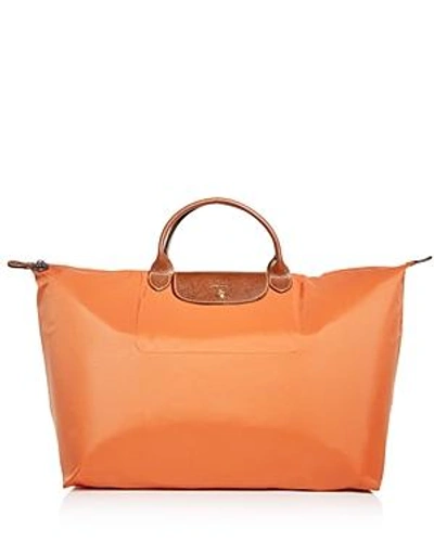 Shop Longchamp Le Pliage Nylon Travel Bag In Orange/gold