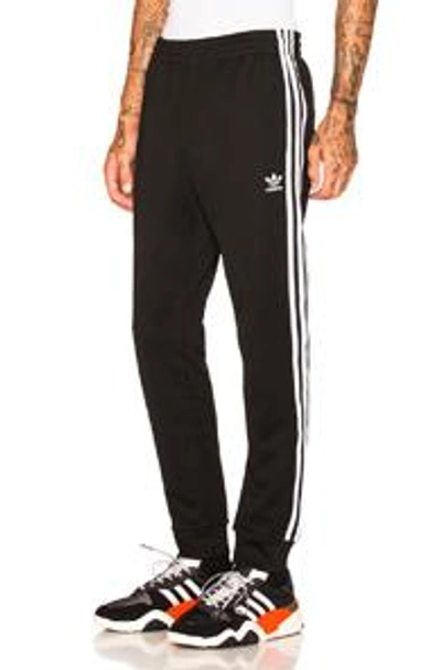 Shop Adidas Originals Ss Track Pants In Black