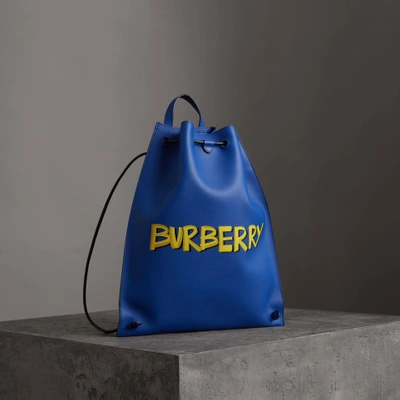 Shop Burberry Graffiti Print Bonded Leather Drawcord Backpack In Denim Blue