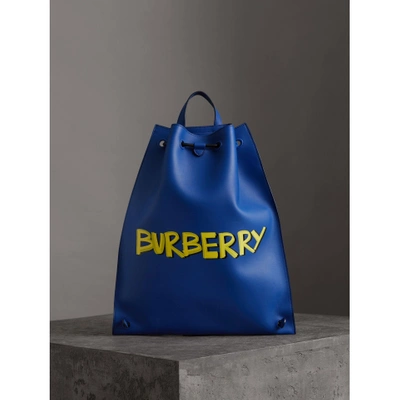 Shop Burberry Graffiti Print Bonded Leather Drawcord Backpack In Denim Blue