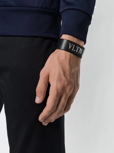 Shop Valentino Garavani Logo Cuff Bracelet - Black