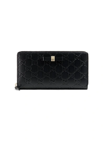 Shop Gucci Bow  Signature Zip Around Wallet - Black