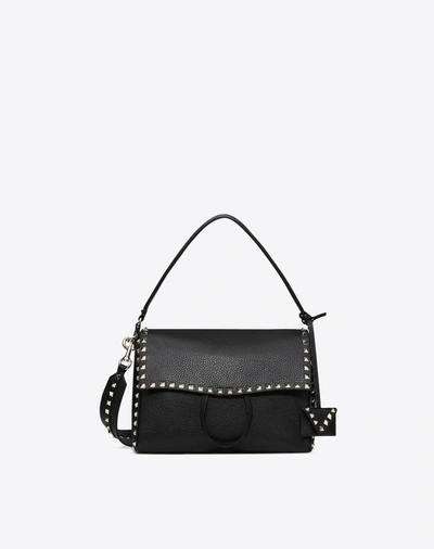 Shop Valentino Rockstud Top Handle Bag In Black