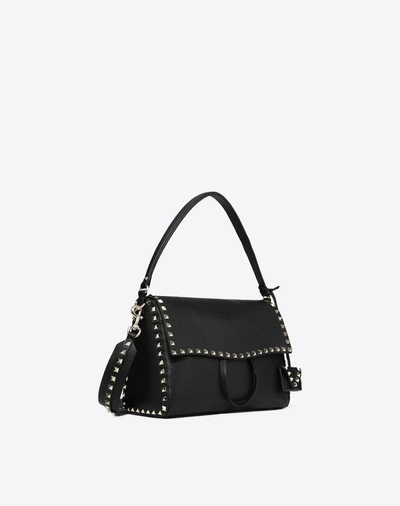 Shop Valentino Rockstud Top Handle Bag In Black