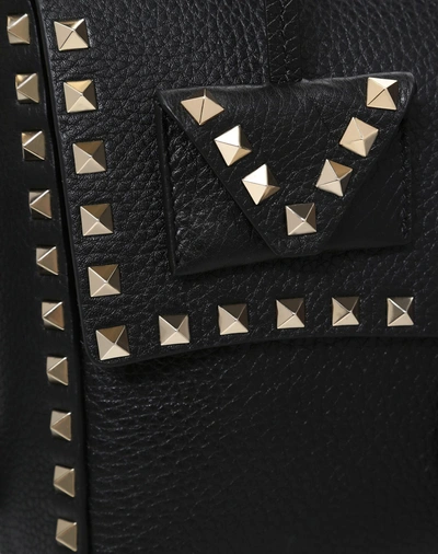 Shop Valentino Rockstud Top Handle Bag In Black