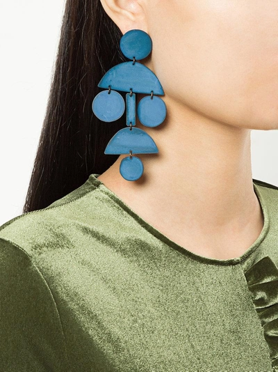 Shop Annie Costello Brown Pom Pom Long Chandelier Earrings - Blue