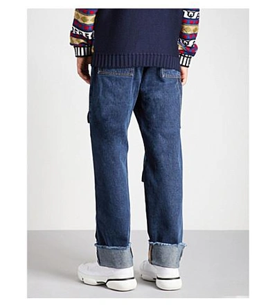 Shop Jw Anderson Multi-pocket Wide-fit Straight Jeans In Indigo