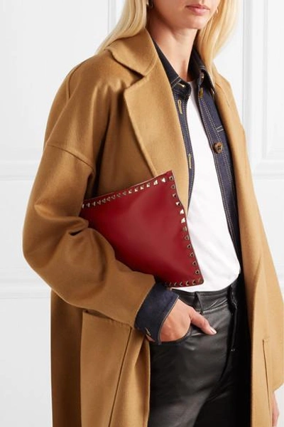 Shop Valentino Garavani The Rockstud Textured-leather Pouch In Red