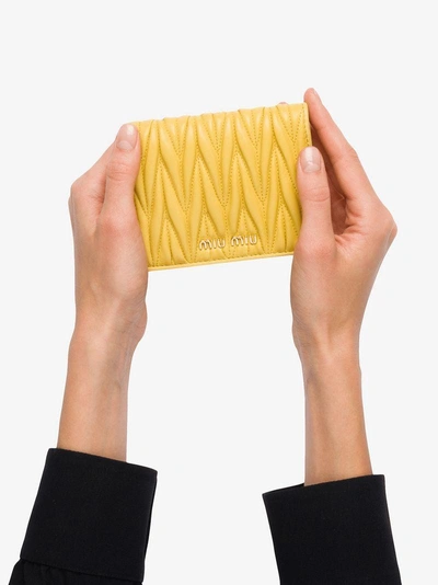 Shop Miu Miu Matelassé Flap Wallet In Yellow