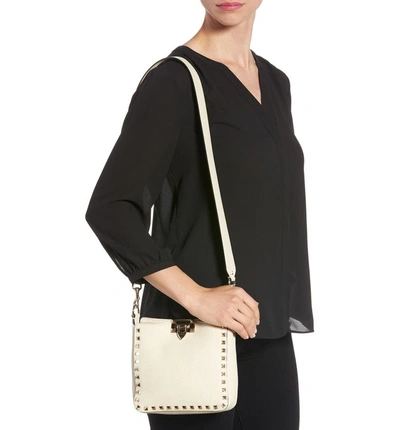 Shop Valentino Rockstud Mini Hobo Crossbody Bag In Ivory