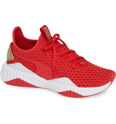 Shop Puma Defy Varsity Sneaker In Ribbon Red/ Metallic Gold