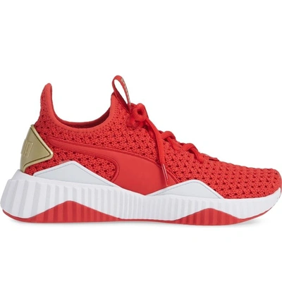 Shop Puma Defy Varsity Sneaker In Ribbon Red/ Metallic Gold