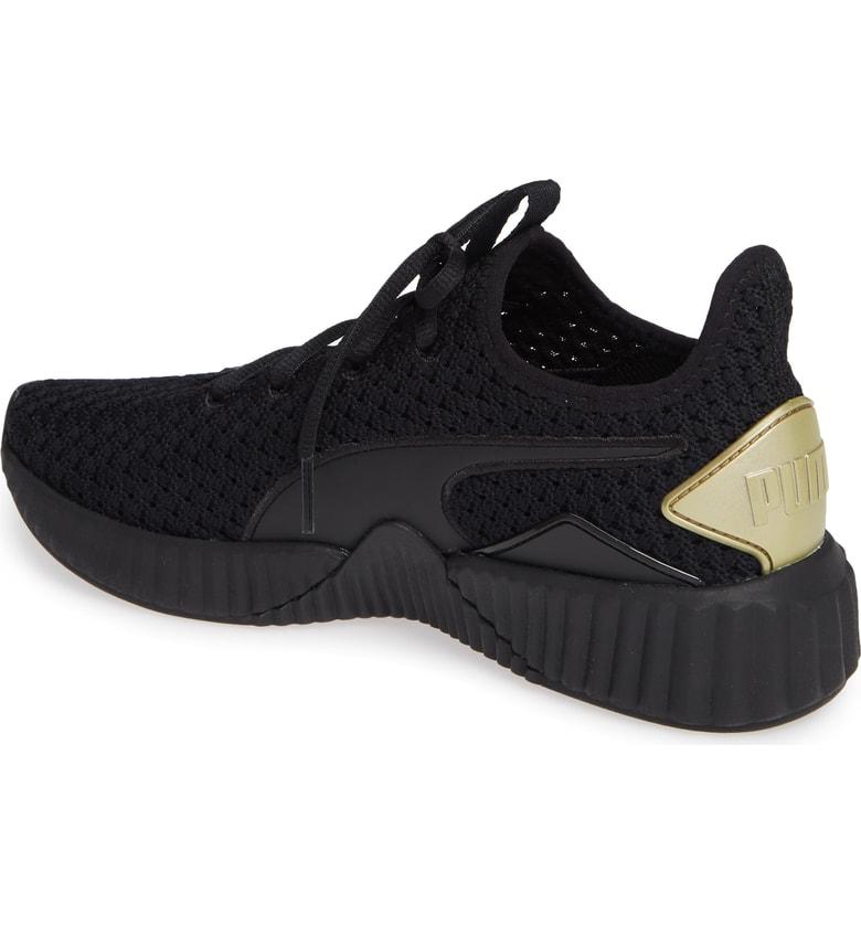 puma defy varsity black and gold