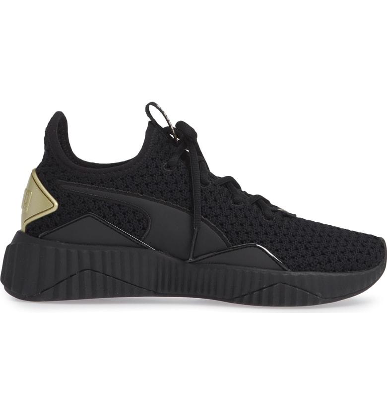 puma defy varsity black and gold