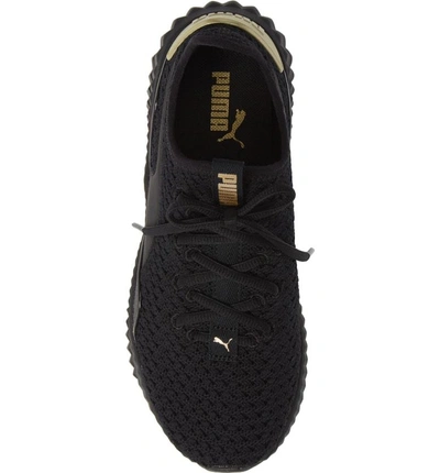 Shop Puma Defy Varsity Sneaker In  Black/ Metallic Gold