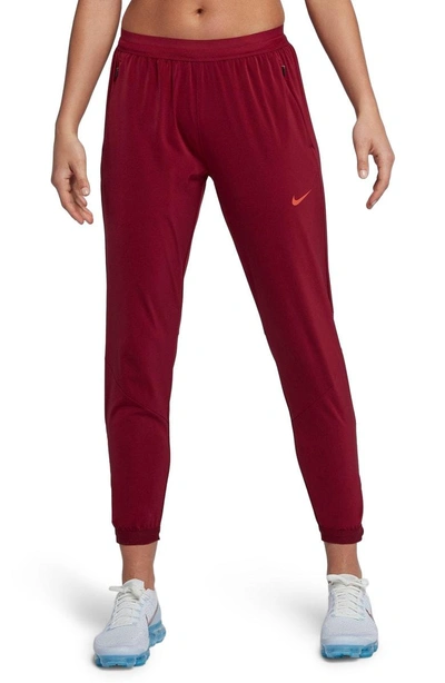 Shop Nike Dry Running Stadium Pants In Team Red/ Vintage Coral