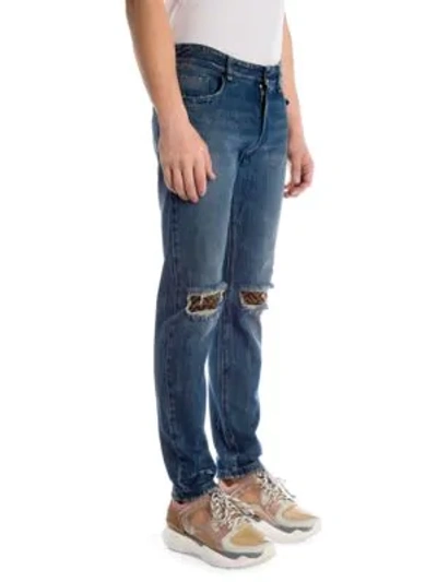 Shop Fendi Distressed Logo Patch Skinny Jeans In Indigo