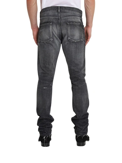 Shop Saint Laurent Slim Fit Jeans With Raw Edges In Nero