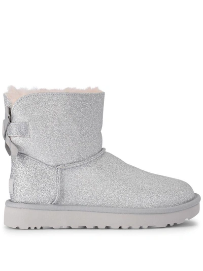 Shop Ugg Mini Bailey Bow Glitter And Silver Sheepskin Ankle Boots In Argento