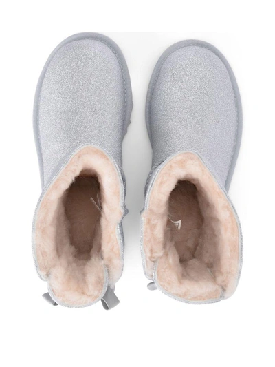 Shop Ugg Mini Bailey Bow Glitter And Silver Sheepskin Ankle Boots In Argento