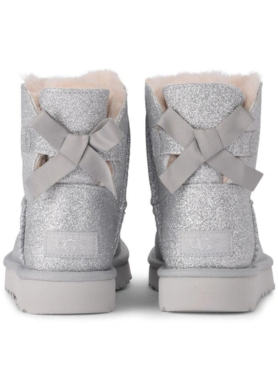 Shop Ugg Mini Bailey Bow Glitter And Silver Sheepskin Ankle Boots In Argento