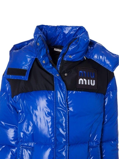 Shop Miu Miu Long Quilted Long Logo Patch Padded Jacket In Bluette